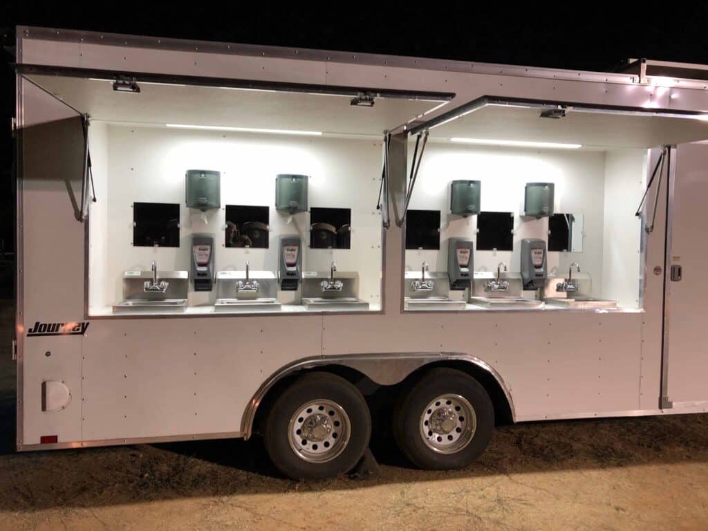 McMichael Waste Services multi-station hand-washing trailer with fresh-water foot-pump sinks