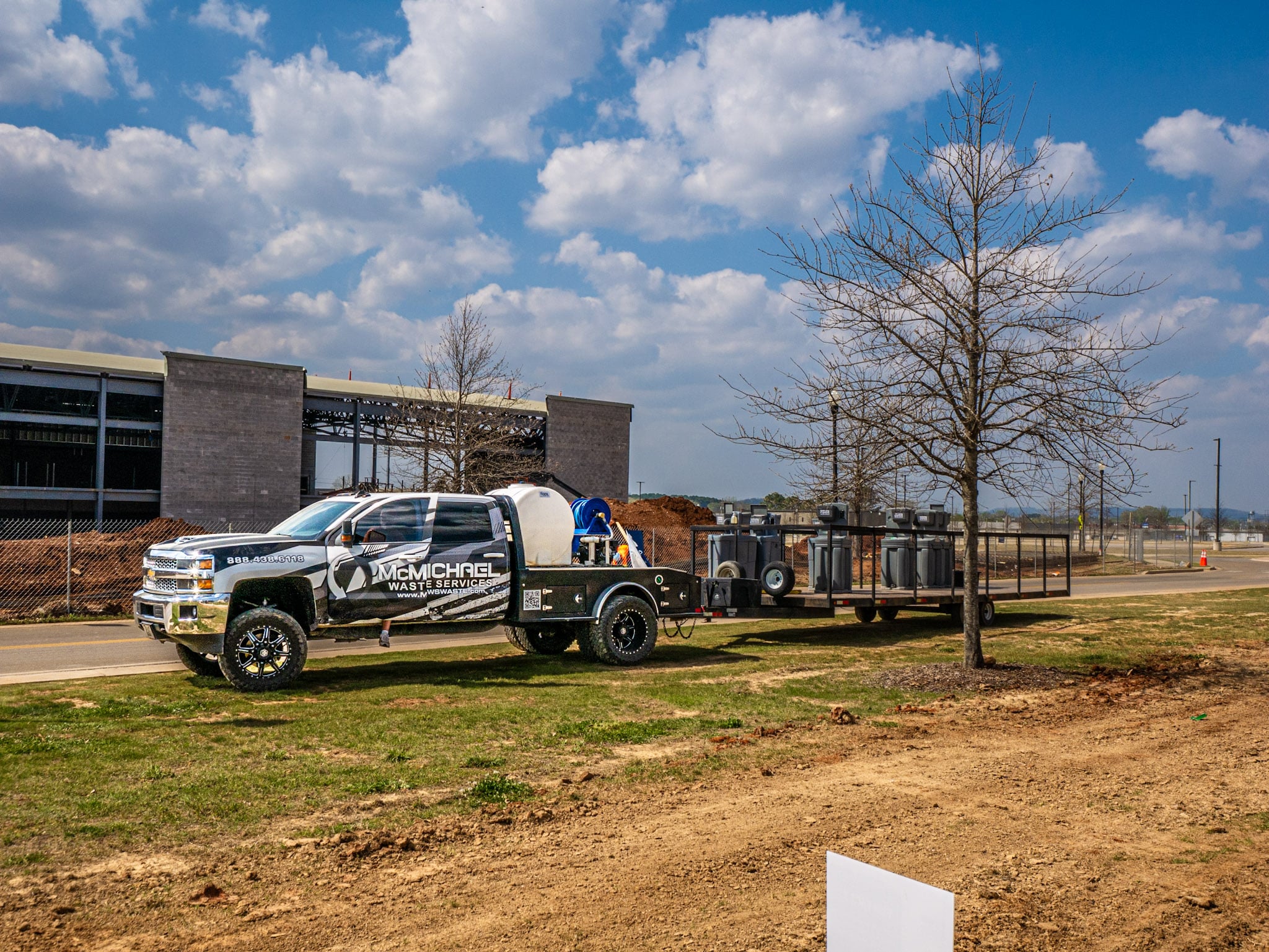 McMichael Waste Services wrapped service truck on a jobsite in Huntsville, Alabama