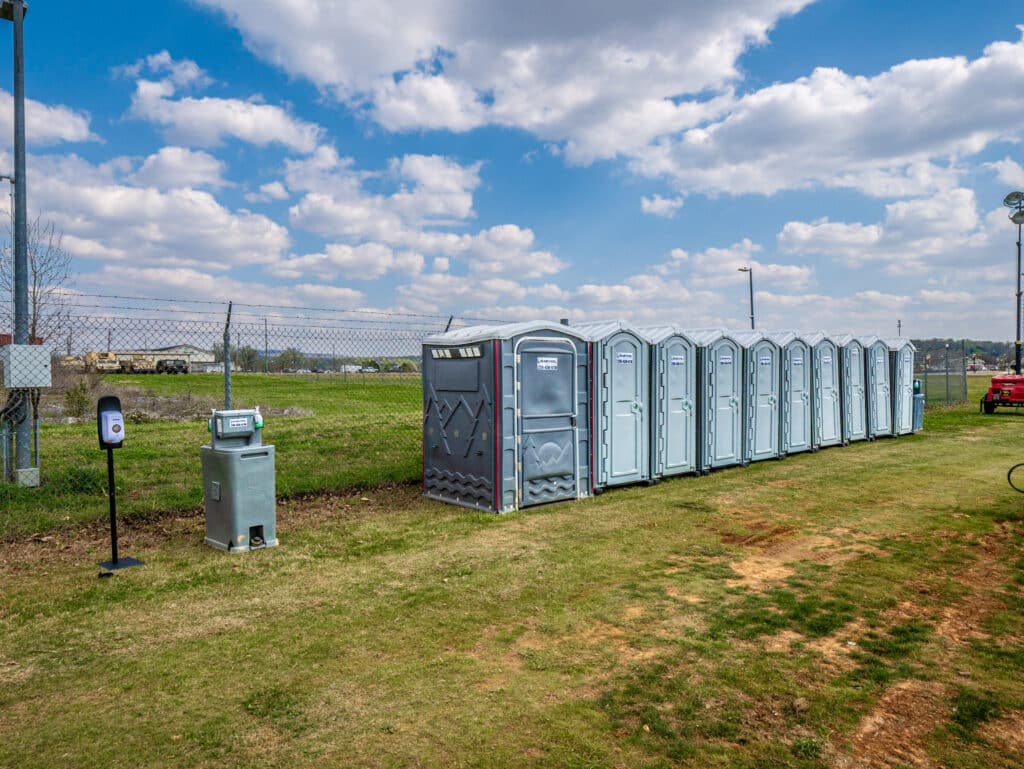 Row of McMichael Waste Services portable toilets set up for an outdoor event in Huntsville, Alabama