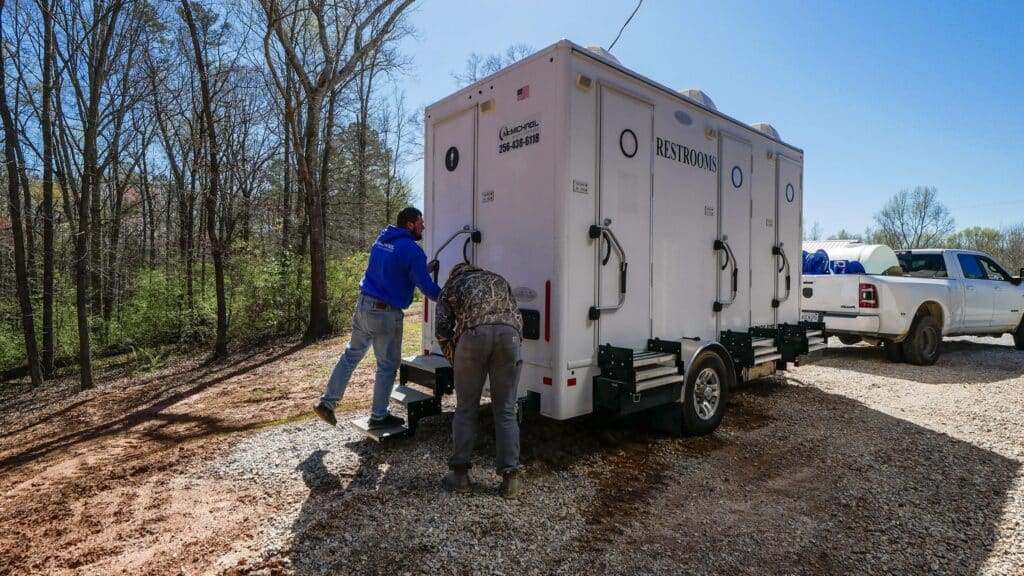 McMichael Waste Services crew delivering a restroom trailer in Alabama