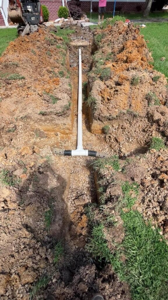 Septic drain field distribution line with PVC fittings installed in Alabama