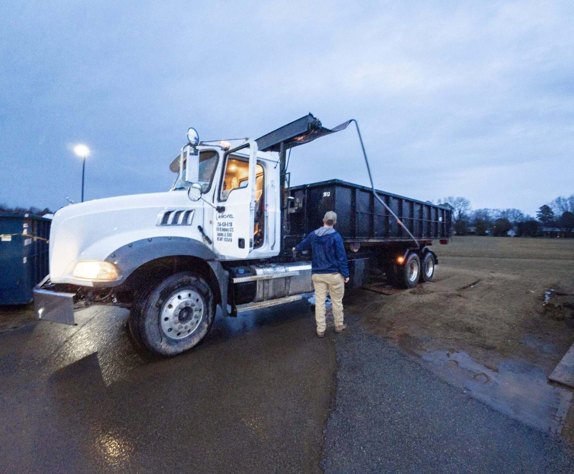 McMichael Waste Services roll-off driver and truck ready for dispatch in Alabama