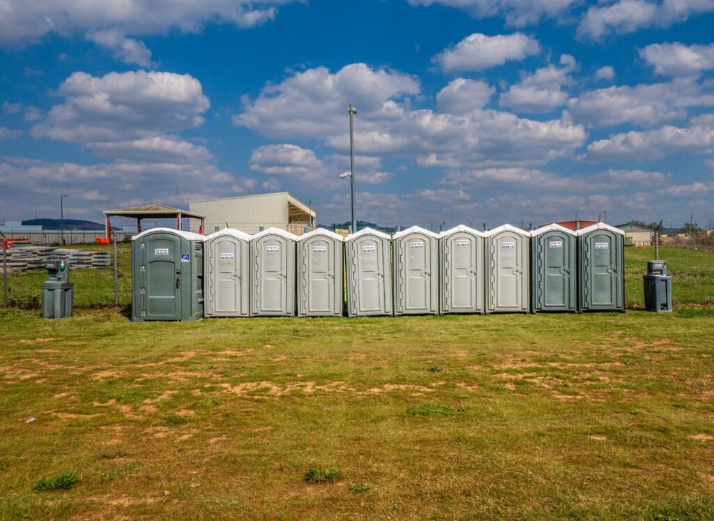 McMichael Waste Services standard and ADA portable toilets on a field in Huntsville, Alabama