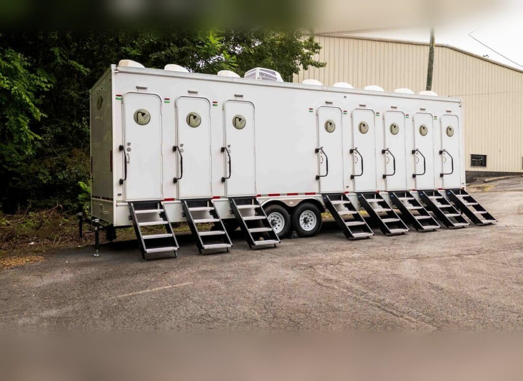 Side view of a multi-stall shower trailer with entry steps at each door