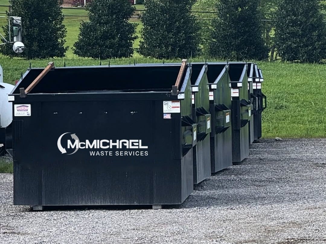 McMichael Waste Services front-load dumpsters lined up in Alabama