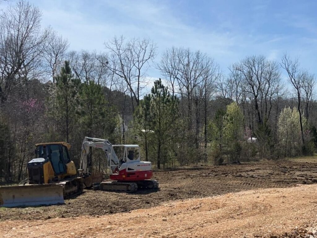 McMichael Waste Services excavator and dozer on a cleared land clearing site in Alabama