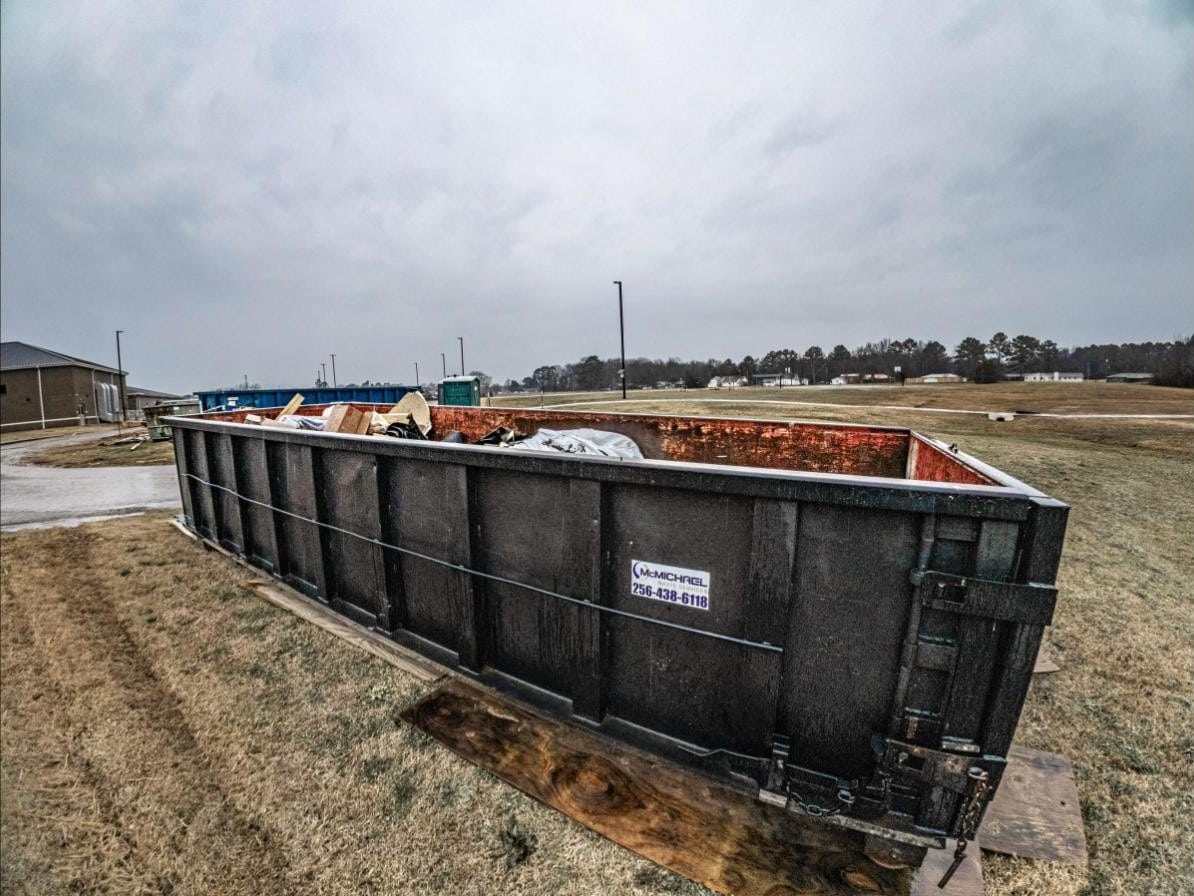 McMichael Waste Services roll-off container loaded on an Alabama jobsite