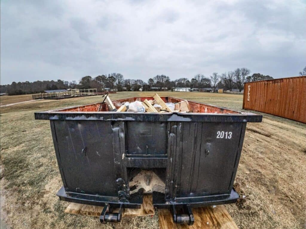 McMichael Waste Services roll-off container loaded with construction debris on an Alabama jobsite