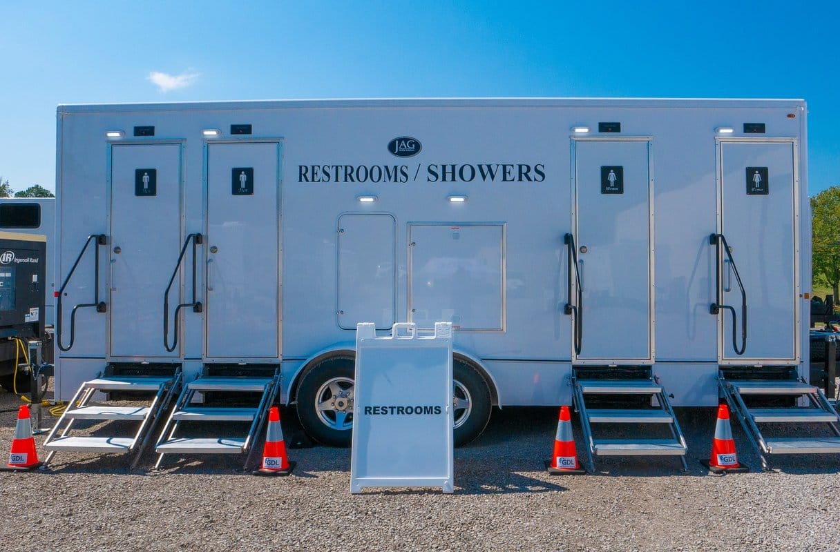 Restroom and shower combination trailer set up with fold-down entry steps at each door